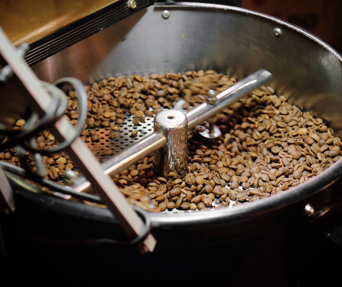 Close-up of SplitShot coffee beans roasting to perfection, highlighting the artisanal process behind our premium reduced-caffeine blend.